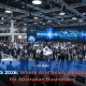 Crowded CES 2026 exhibition hall showcasing large-scale AI and technology displays, with business leaders networking around digital twin, autonomous vehicle, and smart manufacturing demonstrations.